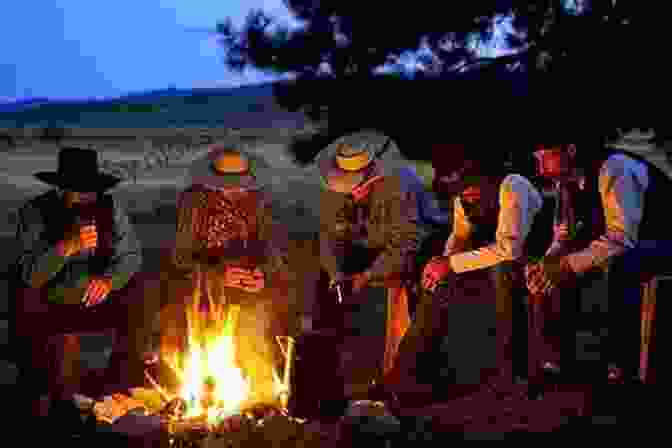 A Photograph Of A Group Of Cowboys Standing Around A Campfire, With A Sunset In The Background The Great American Cowboy: A Ride Through History